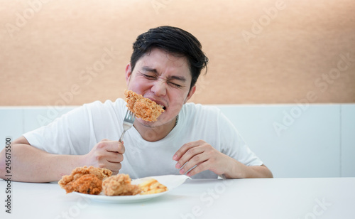 close up focus man bite fried chicken meal for eat at restaurant bar  fast food and healthcare living concept  