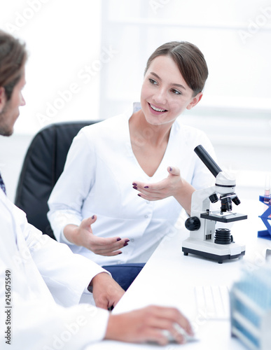 Side view of two scientists conducting a chemical experiment