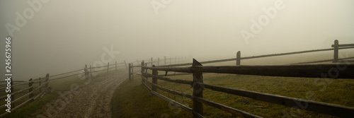 Dirt road in the fog in autumn