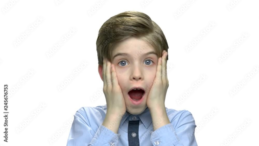Portrait of preteen boy with shocked expression. Surprised child boy with hand on face. Isolated on white background. Portrait of preteen boy with shocked expression. Surprised child boy with hand on face. Isolated on white background.