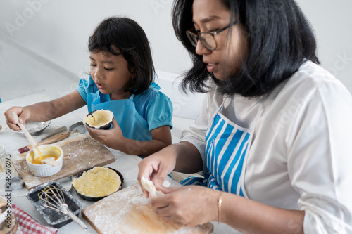 mother and kid learning to make some dough