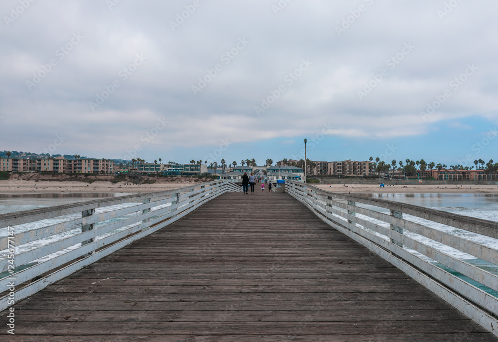 Fototapeta premium Wooden bridge to the ocean. Pacific Beach Pier or Crystal Pier.