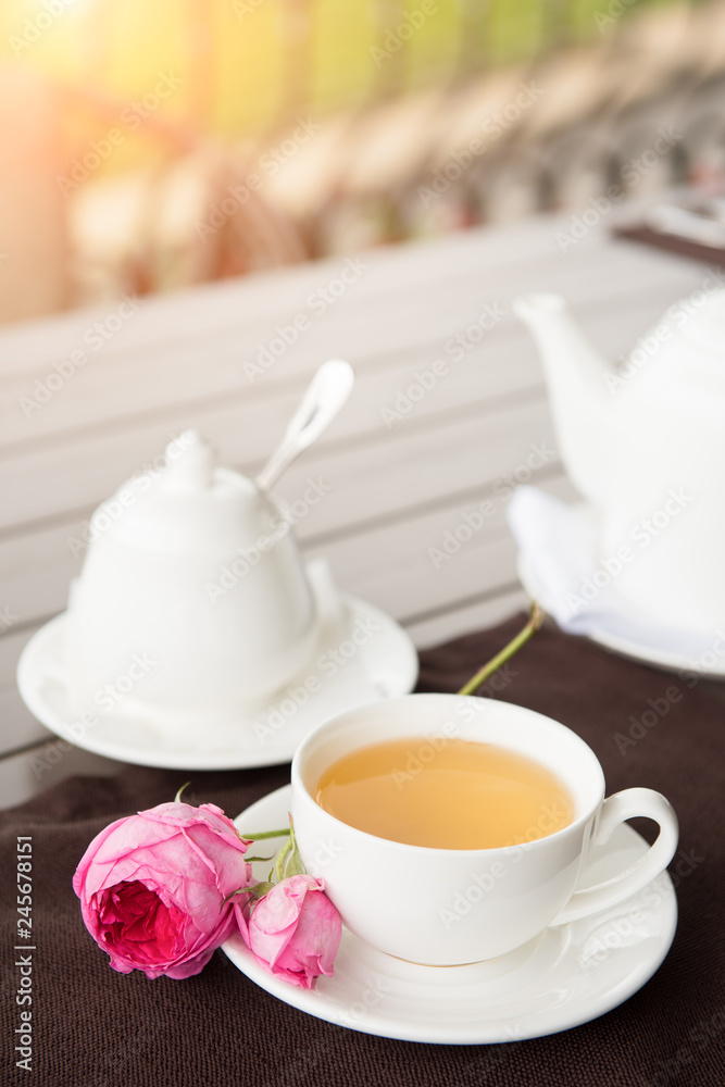 White tea Cup with teapot and sugar pot on the table White tea Cup with teapot and sugar pot on the table