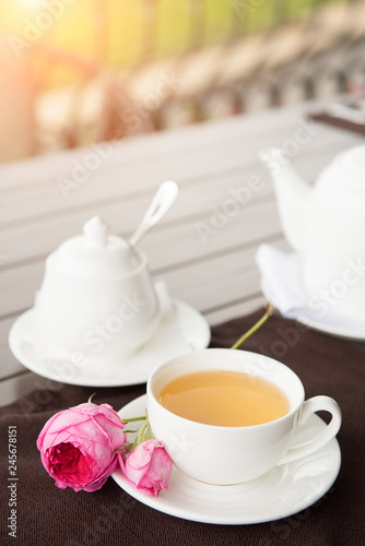 White tea Cup with teapot and sugar pot on the table