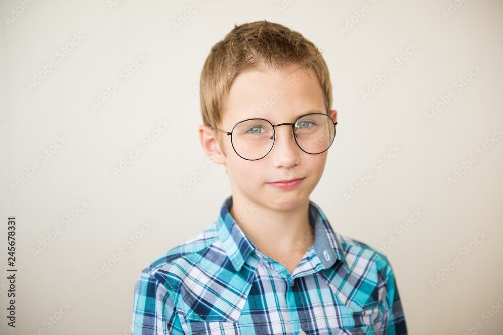 Sad boy with glasses on light background. Selective focus Sad boy with glasses on light background. Selective focus