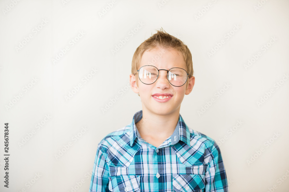 Teenager kid boy squints in myopia correction glasses Teenager kid boy squints in myopia correction glasses