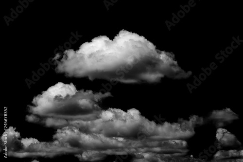 White fluffy clouds in the black sky background.