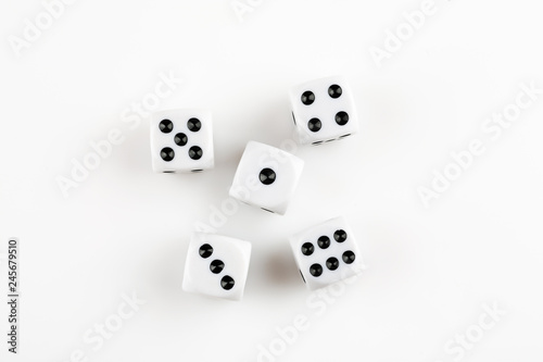 Pile of white with black dots dice on a white background