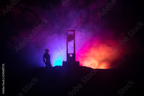 Horror view of Guillotine. Close-up of a guillotine on a dark foggy background. photo