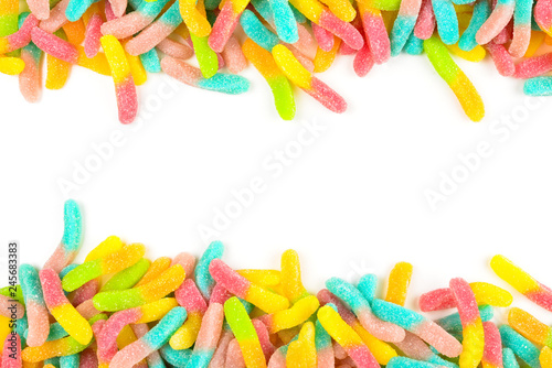 Frame of assorted gummy candies isolated on white. Top view. Space for text or design.