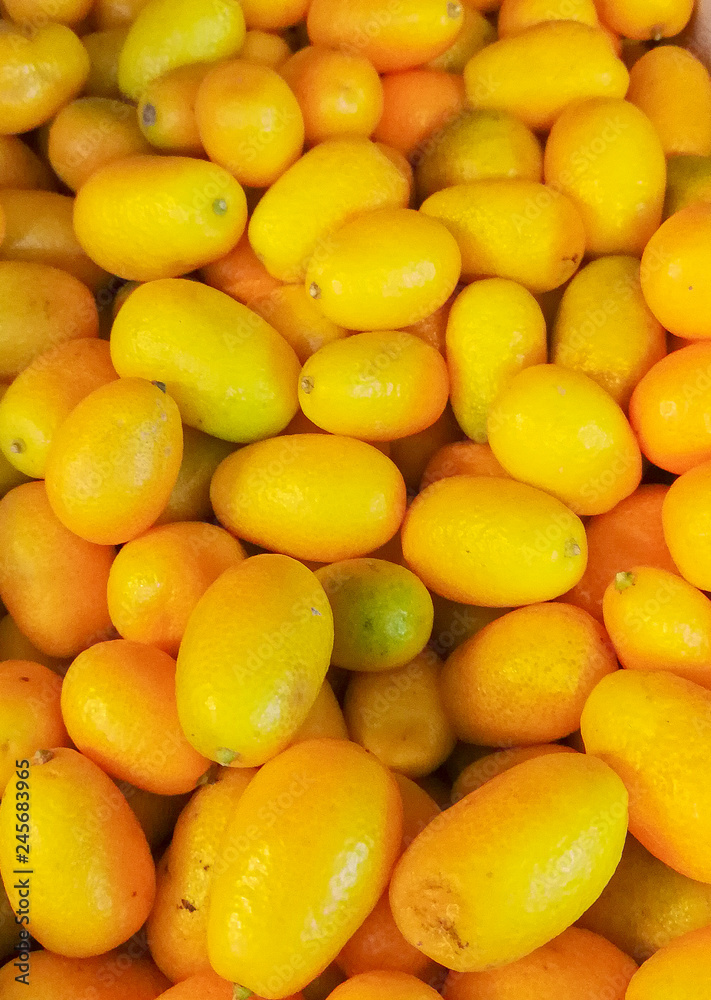 Bunch of fresh kumquats fruits in the organic food market