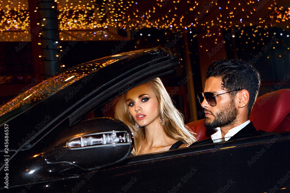 Couple in luxury car. Night life. Stock Photo