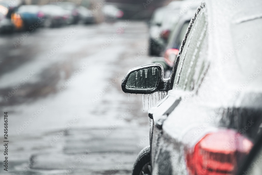 Freezing rain ice coated car. Black vehicle car covered in freezing