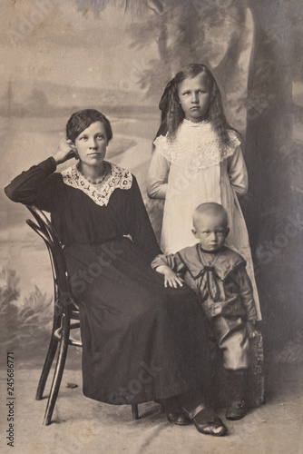 RUSSIA - CIRCA 1905-1910: A portrait of young woman with children in studio, Vintage Carte de Viste Edwardian era photo