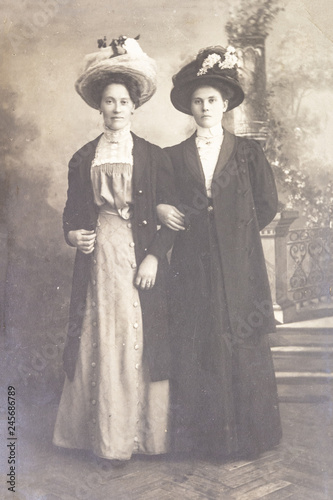 RUSSIA - CIRCA 1905-1910: Full body shot of two young women in studio, Vintage Carte de Viste Edwardian era photo