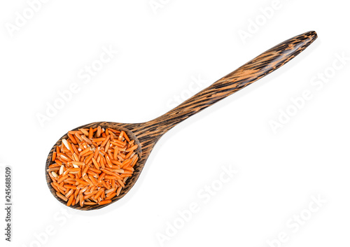 brown rice in wood spoon isolated on white background