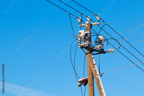 Electric pole and wires covered with snow