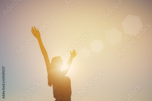 Silhouette of a girl with arms outstretched, sun, rays, evening, sunset photo