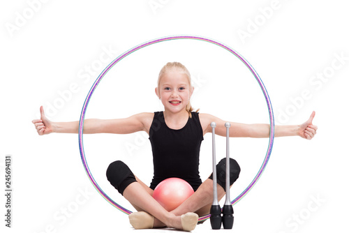 Teen girl holding rhythmic gymnastics accessories