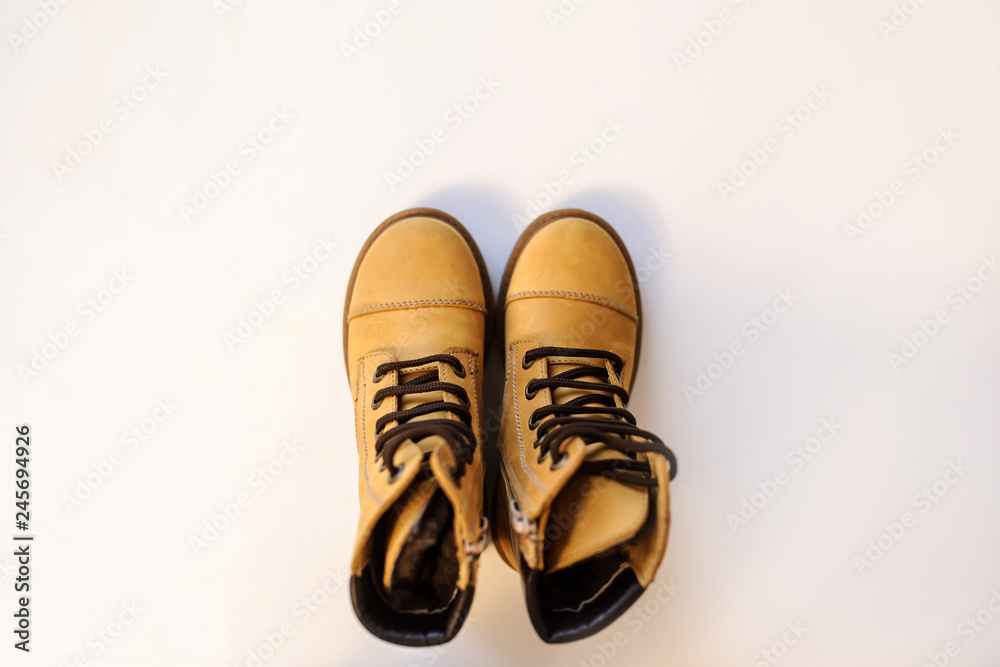 top view of a pair of yellow leather child shoes on a white background top view of a pair of yellow leather child shoes on a white background