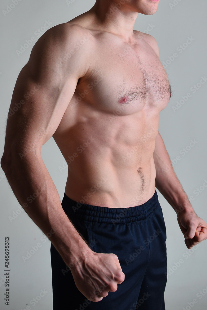 Fototapeta premium young muscular man flexing his muscles