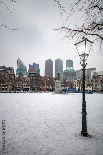 Snow on the central place, Spui in Dutch, usually crowded with people getting diner and drink during the sunset and warm autumn weather in The Hague, Netherlands photo