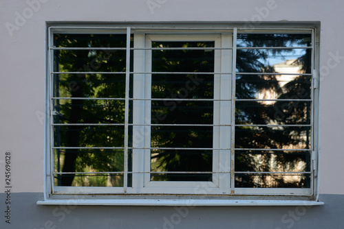 large window with metal bars on the wall of the building