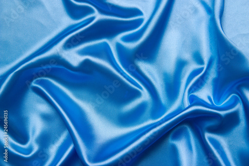 Background from a blue satin fabric with picturesque folds
