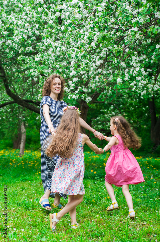 Family in blooming apple blossom garden. Family in blooming apple blossom garden.