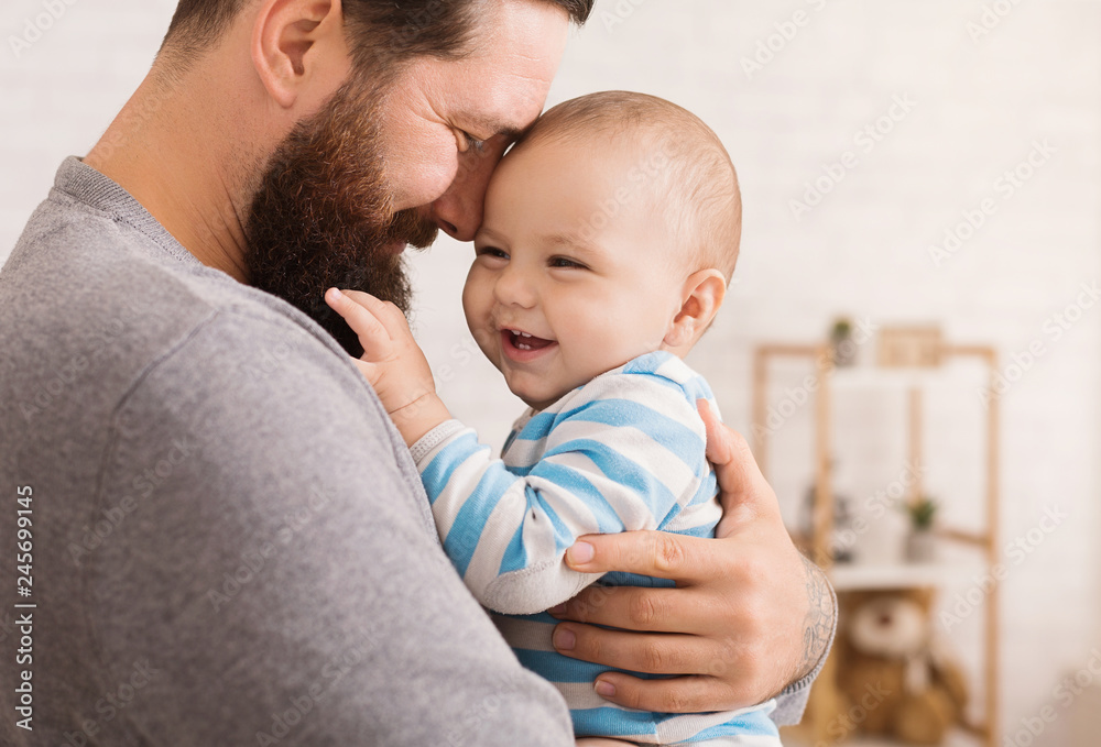 Loving father embracing his cute baby son Loving father embracing his cute baby son