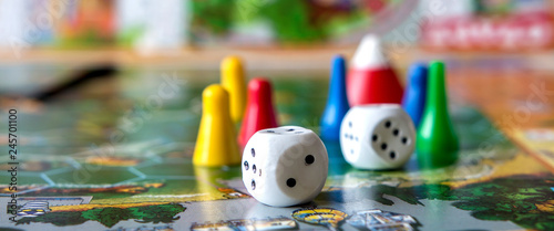 concept of board games. Dice, chips and cards on a green background long banner photo