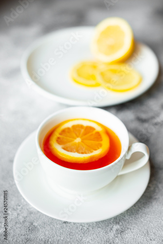 Tea, lemon, hot, drink. Tasty fragrant hot tea with a lemon on a concrete background