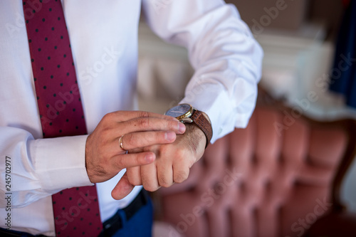 the groom looks at his watch