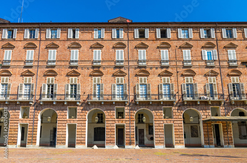 Prefecture Palazzo del Governo Palace brick building with arches, windows and shutters on Castle Square Piazza Castello in historical centre of Turin Torino city with clear blue sky, Piedmont, Italy photo