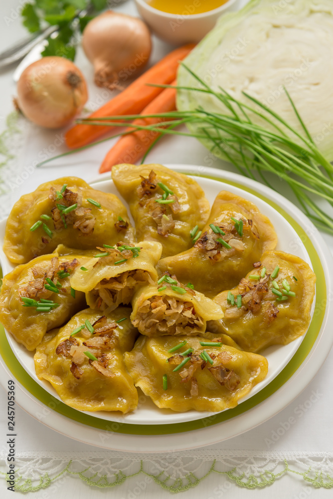 Dumplings with cabbage and fried onions. This is a very popular food in Poland, Ukraine and Russia Dumplings with cabbage and fried onions. This is a very popular food in Poland, Ukraine and Russia
