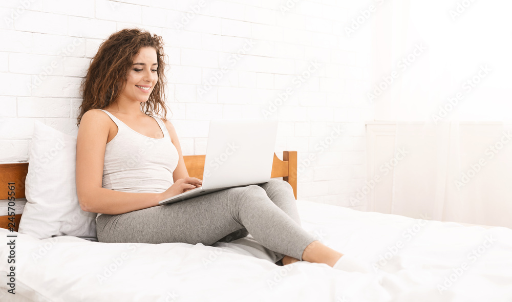 Young woman reading website for school test on laptop