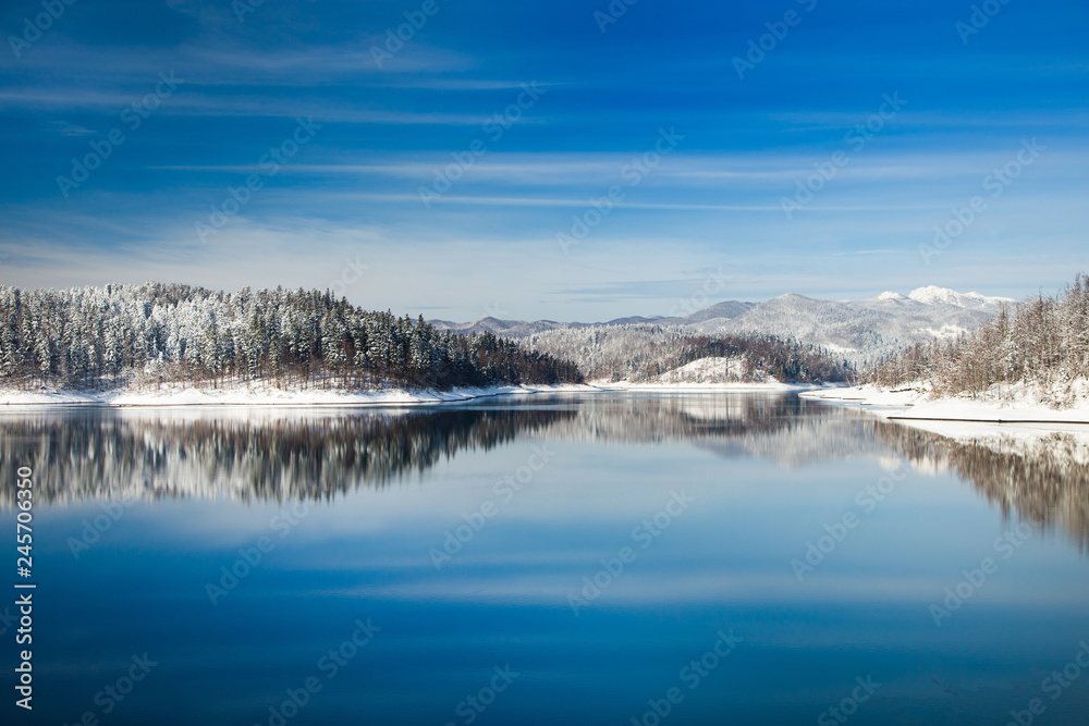 Gorski kotar, Lokvarsko lake in Croatia, beautiful landscape in winter, forest reflecting in the water