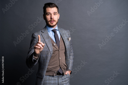 Caucasian businessman with finger touch imagery panel.