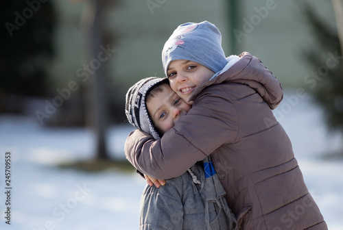 Children hugging on snow