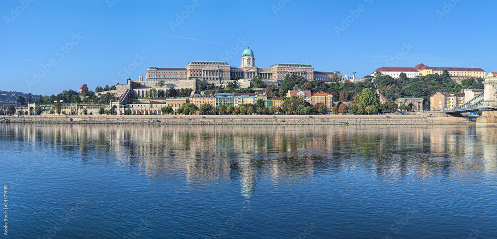 Budapest, Hungary. Panoramic view of Castle Hill with Royal Palace, Castle Garden, Sandor Palace, Castle Hill Funicular and fragment of Szechenyi Chain Bridge. View from Danube in the morning.