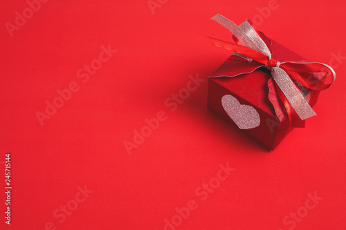 Gift box with a red bow on red background - Image