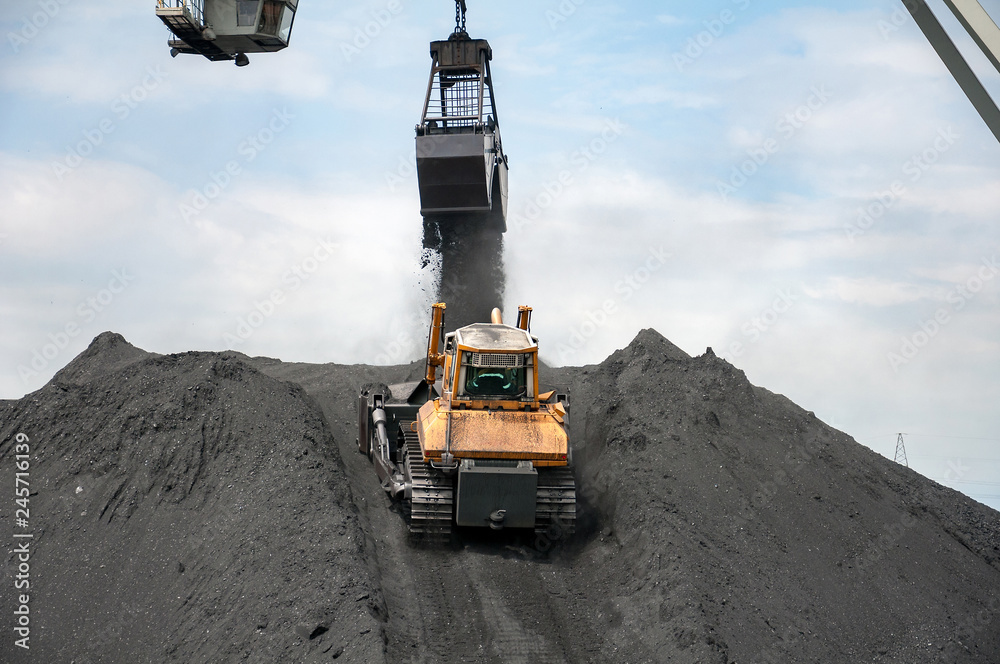 caterpillar tractor and travelling crane load black coal on supply field of thermoelectric power station caterpillar tractor and travelling crane load black coal on supply field of thermoelectric power station