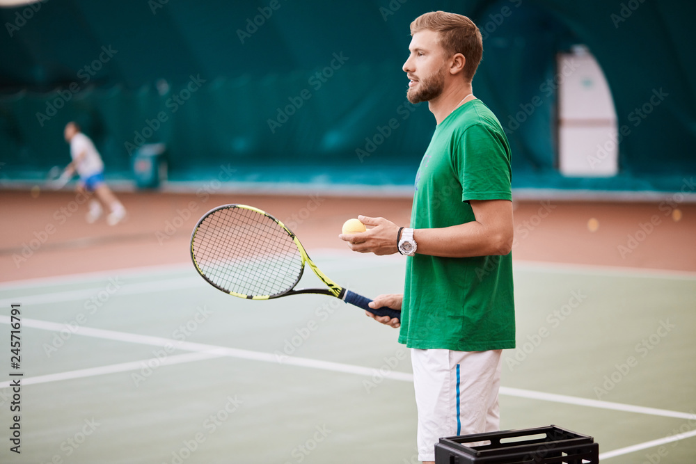 Indoor Tennis match which a serving male player of european appearance