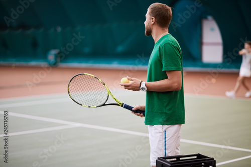 Indoor Tennis match which a serving male player of european appearance