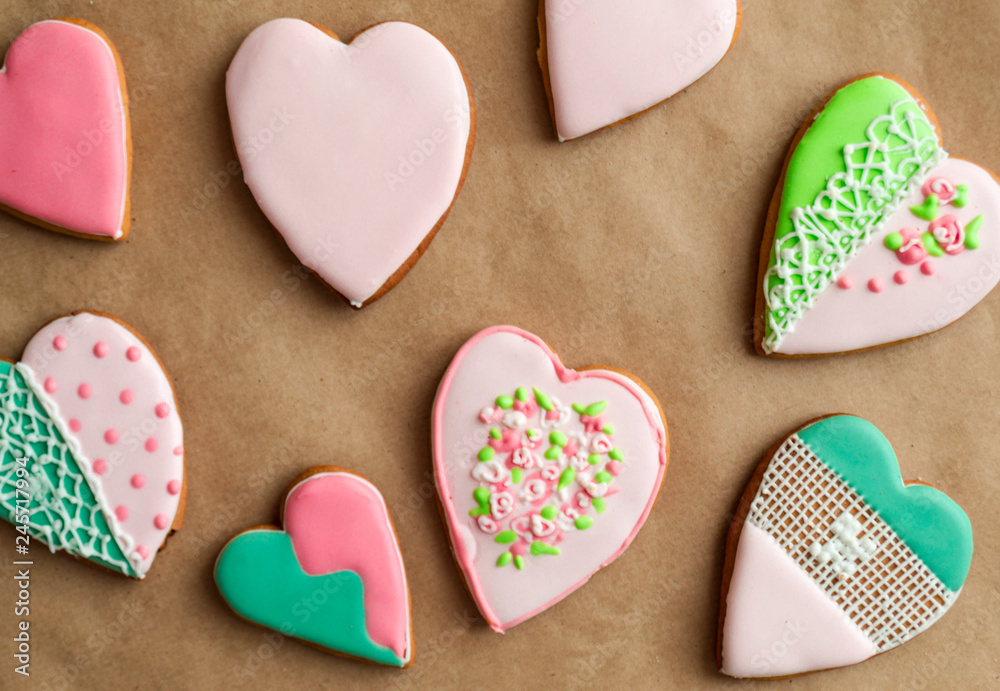 Gingerbread gingerbread in pink glaze, on craft background. Bakery products. Place for text. Gingerbread pattern Background. Gingerbread gingerbread in pink glaze, on craft background. Bakery products. Place for text. Gingerbread pattern Background.