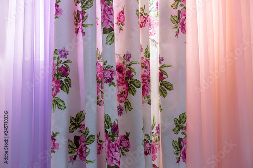 Curtains with floral pattern and tulle on the living room window.