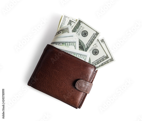 Brown leather wallet with dollars on white paper background. Flat lay. photo