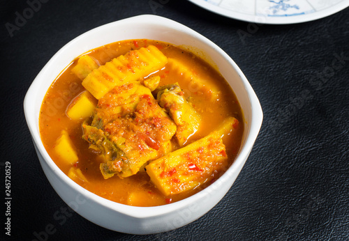 Thai Sour Curry orange with fish and mixed veggies,Southern Thai Spicy Sour Yellow Curry with Sea Bass and Coconut Shoots