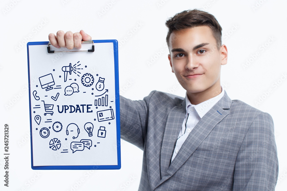 Business, technology, internet and networking concept. Young entrepreneur showing keyword: Update Business, technology, internet and networking concept. Young entrepreneur showing keyword: Update