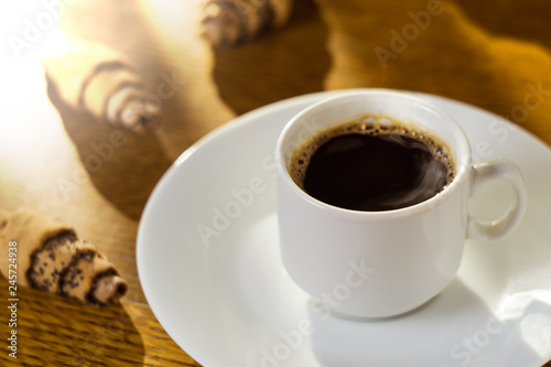 coffee cup with cookies. Blurred background. Morning coffee. White cup.